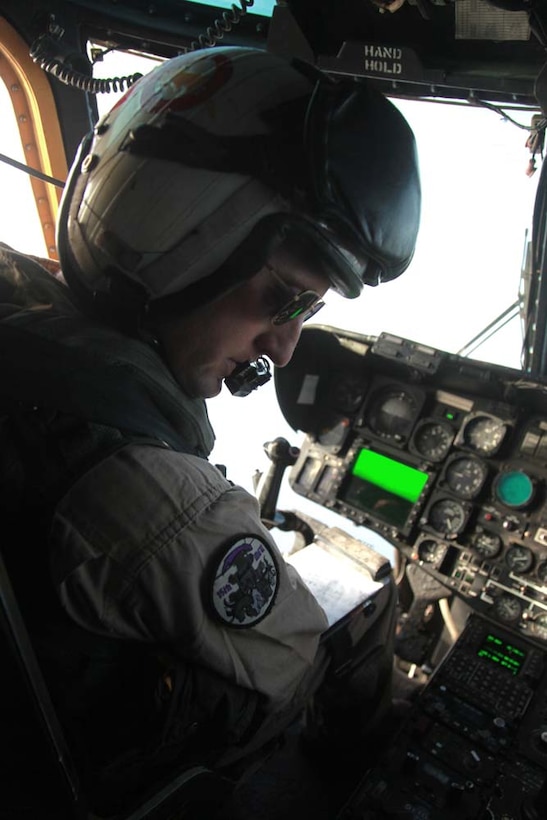 Capt. Bryan J. Sarg, CH-53E Super Stallion pilot, Marine Medium Helicopter Squadron 364 (Rein.), 15th Marine Expeditionary Unit, checks his global positioning system during air refueling training in the U.S. 5th Fleet area of responsibility, March 14. The 15th MEU is deployed as part of the Peleliu Amphibious Ready Group as a U.S. Central Command theater reserve force, providing support for maritime security operations and theater security cooperation efforts in the U.S. 5th Fleet area of responsibility. (U.S. Marine Corps photo by Cpl. John Robbart III)