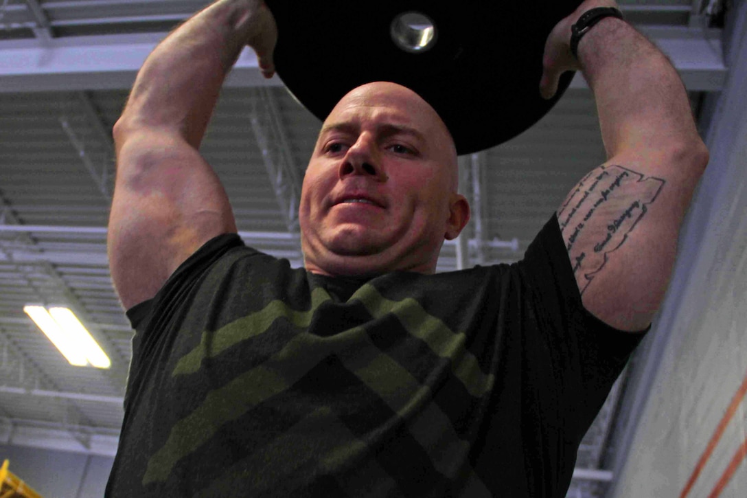 Gunnery Sgt. Nate McIntosh pushes through a CrossFit exercise with Marines from Recruiting Station Twin Cities March 18. McIntosh was one of 20 Marines who attended the three-day fitness engagement. 