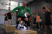 Recruiting Substation Mankato's Staff Sgt. Jason Hefner leads his team through a CrossFit exercise March 18. Hefner was one of 20 Marines with Recruiting Station Twin Cities who attended the three-day fitness engagement.