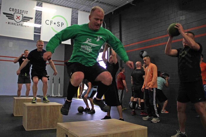 Recruiting Substation Mankato's Staff Sgt. Jason Hefner leads his team through a CrossFit exercise March 18. Hefner was one of 20 Marines with Recruiting Station Twin Cities who attended the three-day fitness engagement.
