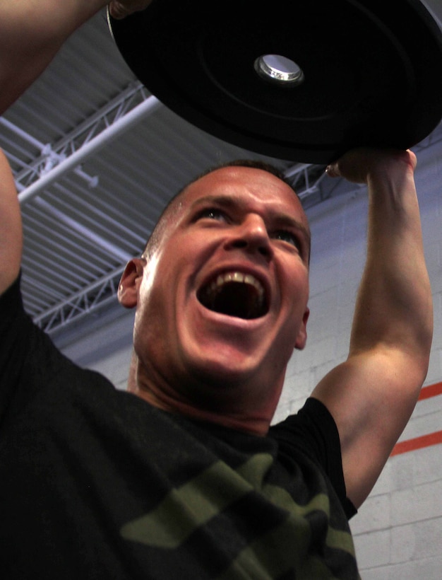 Recruiting Substation Eau Claire's Gunnery Sgt. Timothy Anderson motivates his team during a CrossFit exercise March 18. Anderson was one of 20 Marines with Recruiting Station Twin Cities who attended the three-day fitness engagement.