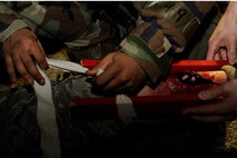 Airman 1st Class Roosevelt Cooper, and Airman Steven Schulze, 8th Logistics Readiness Squadron, splints a role player’s simulated leg fracture during exercise Beverly Midnight 13-2 at Kunsan Air Base, Republic of Korea, March 19, 2013. The scenario tested the 8th LRS’s ability to respond to and treat injured personnel following a ground attack. (U.S. Air Force photo by Senior Airman Marcus Morris/Released)