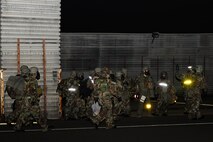 Airmen from the 35th Fighter Squadron relocate to a new operating facility after a simulated mortar strike damaged their building during exercise Beverly Midnight 13-2 at Kunsan Air Base, Republic of Korea, March 19, 2013. The scenario tested the members’ ability to work from a different location while maintaining oversight of the mission. (U.S. Air Force photo by Senior Airman Marcus Morris/Released)