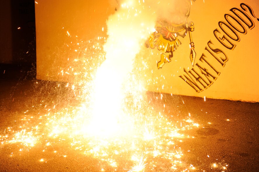 A smoke grenade goes off during exercise Beverly Midnight 13-2 at Kunsan Air Base, Republic of Korea, March 19, 2013. Members of the 8th Civil Engineer Squadron explosive ordnance disposal team used smoke grenades and ground-burst simulators to demonstrate  tactical ballistic missile attacks on compounds around the base to create a more realistic training environment. (U.S. Air Force photo by Senior Airman Marcus Morris/Released)