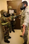 Senior Airman Emily Gray, 8th Medical Operations Squadron, checks Staff Sgt. Hezekiah Barrett, 8th MDOS, for  signs of contamination during exercise Beverly Midnight 13-2 at Kunsan Air Base, Republic of Korea, March 19, 2013. Barrett became contaminated as a result of performing a post-attack reconnaissance sweep around his contaminated facility. (U.S. Air Force photo by Senior Airman Marcus Morris/Released)