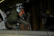 Capt. Ruben Amezaga, 35th Fighter Squadron, dons his helmet during exercise Beverly Midnight 13-2 at Kunsan Air Base, Republic of Korea, March 19, 2013. Beverly Midnight 13-2 was a joint exercise involving US and ROK air forces and evaluated their ability to respond to various scenarios including practicing part of the base’s mission to stand ready to “Take the Fight North.” (U.S. Air Force photo by Senior Marcus Morris/Released)