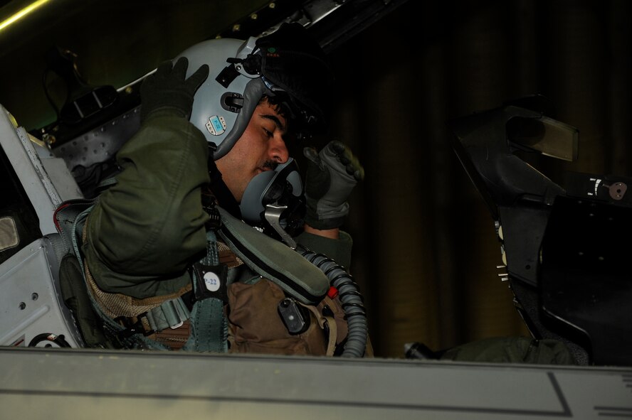 Capt. Ruben Amezaga, 35th Fighter Squadron, dons his helmet during exercise Beverly Midnight 13-2 at Kunsan Air Base, Republic of Korea, March 19, 2013. Beverly Midnight 13-2 was a joint exercise involving US and ROK air forces and evaluated their ability to respond to various scenarios including practicing part of the base’s mission to stand ready to “Take the Fight North.” (U.S. Air Force photo by Senior Marcus Morris/Released)