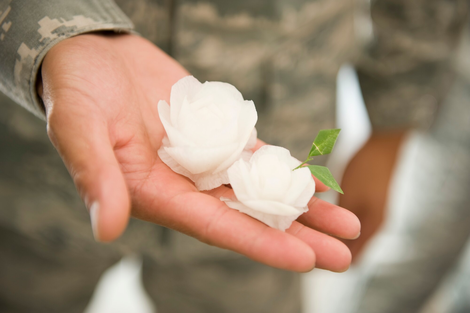 An Airman holds a flower made from a radish during a cultural exchange visit Korat Pittyakom School during Cope Tiger 13 in Nakhon Ratchasima, Thailand, March 18, 2013. Approximately 50 exercise pariticipants visited the school during a cultural exchange visit. More than 300 U.S. service members are participating in CT13, which offers an unparalleled opportunity to conduct a wide spectrum of large force employment air operations and strengthen military-to-military ties with two key partner nations, Thailand and Singapore. (U.S. Air Force photo/2nd Lt. Jake Bailey)
