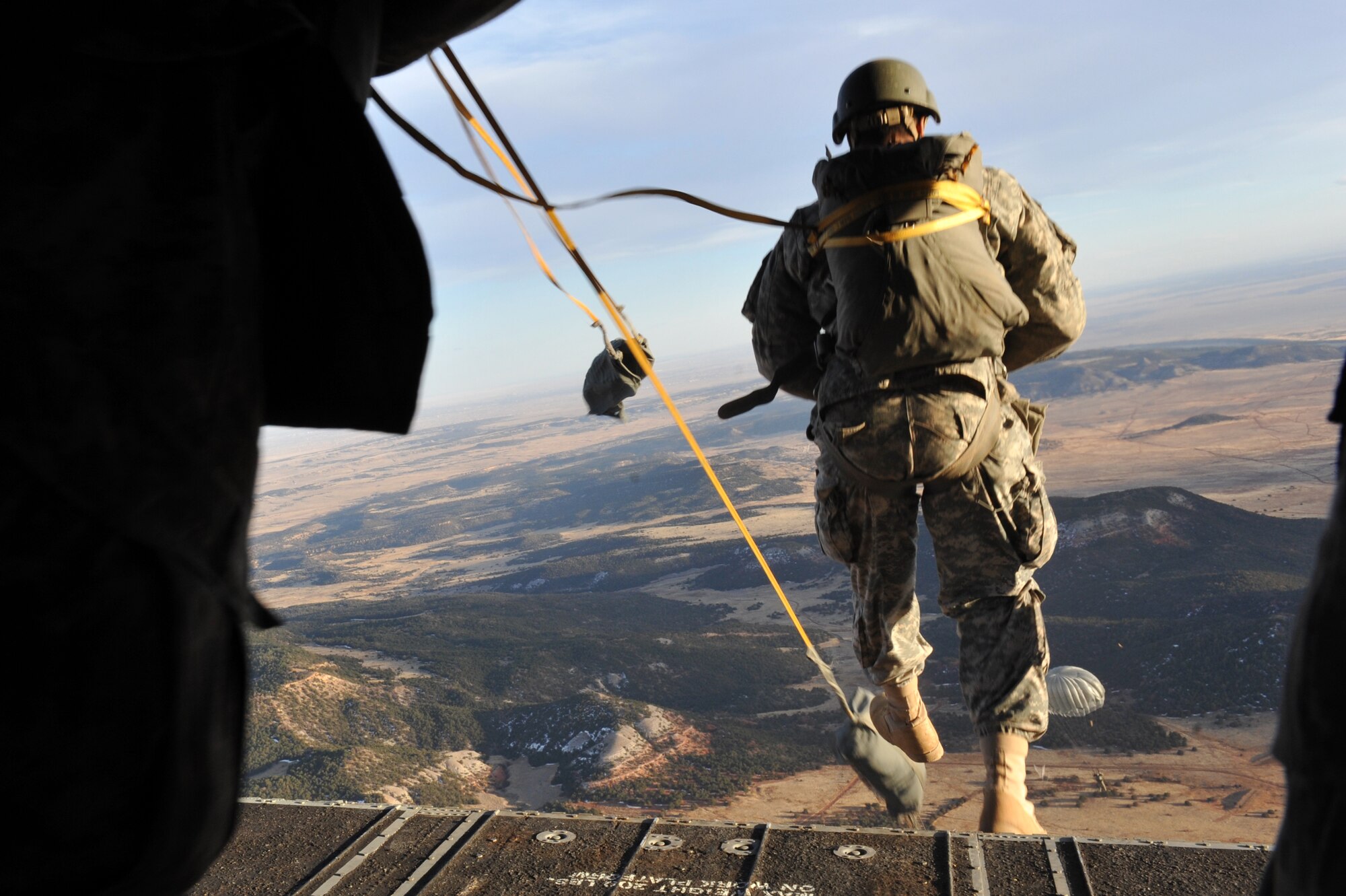 A 10th Special Forces Group member parachutes from a CH-47 Chinook for a training mission March 6, 2013, at Fort Carson, Colo. With the assistance of the Colorado Army National Guard Aviation Support Facility members and assets, 10th SFG members parachuted from the Chinook as part of a training mission. (U.S. Air Force photo by Airman 1st Class Riley Johnson/Released)