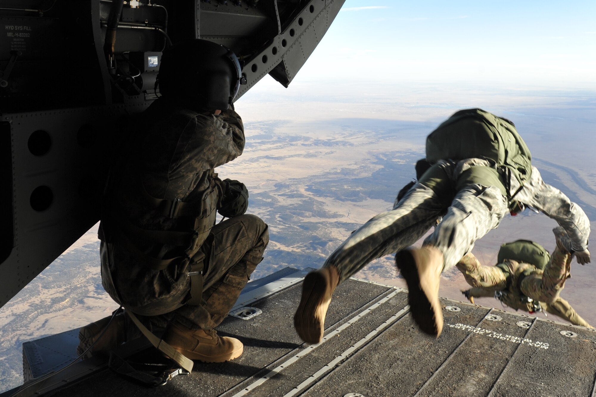 The 10th Special Forces Group members parachute from a CH-47 Chinook for a training mission March 6, 2013, at Fort Carson, Colo. With the assistance of the Colorado Army National Guard Aviation Support Facility members and assets, the Special Forces members performed high altitude low opening parachute jumps from an elevation of 13,000 feet. (U.S. Air Force photo by Airman 1st Class Riley Johnson/Released)