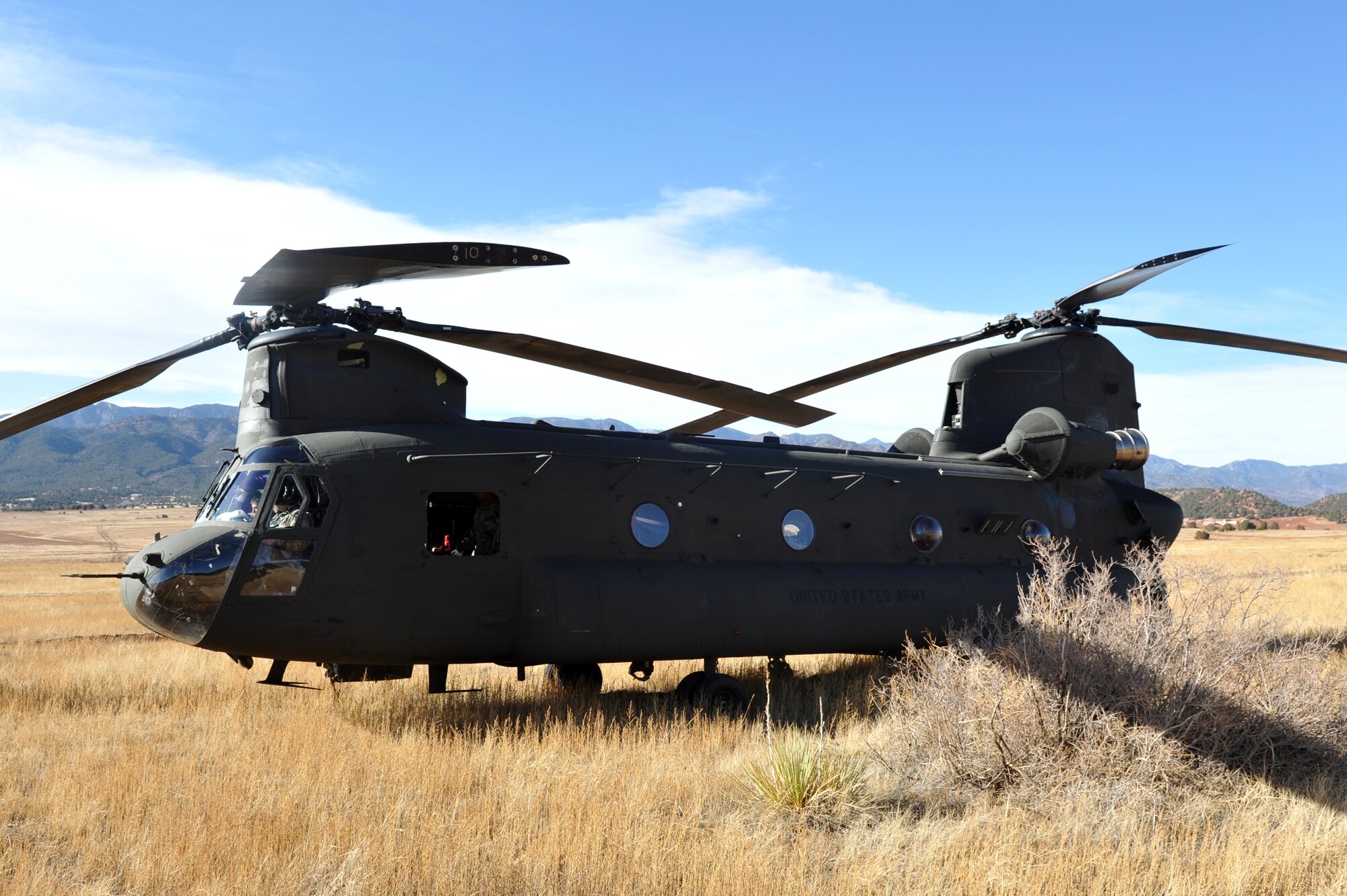 A CH-47 Chinook crew from the Colorado Army National Guard Aviation Support Facility waits for 10th Special Forces Group members to embark March 6, 2013, Fort Carson, Colo.  The Special Forces members performed parachute jumps from the Chinook as part of a training mission. (U.S. Air Force photo by Airman 1st Class Riley Johnson/Released)