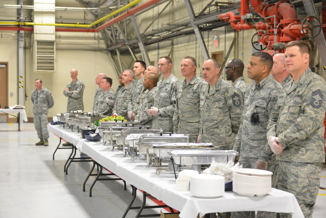 Volunteers from the D.C. National Guard listen to various speakers during the Joint National Guard Prayer Breakfast held by the 113th Wing, DCANG, before serving the numerous individuals in attendance for the event.  The breakfast is an annual event held on Joint Base Andrews to emphasize spiritual resiliency within the unit. (U.S. Air Force photo/Master Sgt. Dennis Young)  