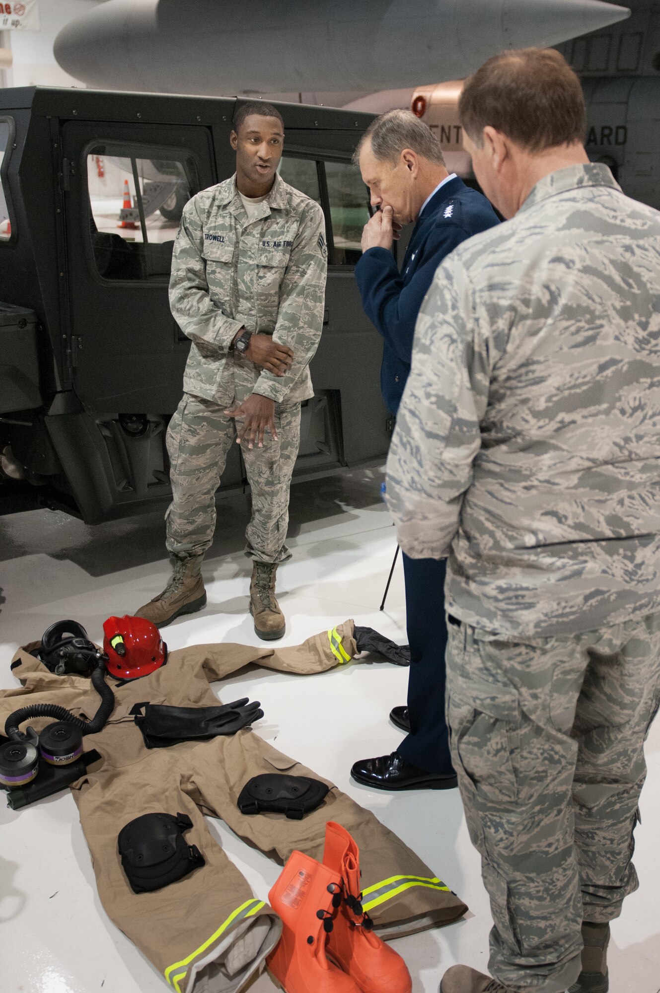 Senior Airman Dwight Trowell, a Fatality Search and Recovery Team member in the Kentucky Air National Guard’s 123rd Force Support Squadron, discusses FSRT protective gear with General William M. Fraser III, commander of U.S. Transportation Command, during a tour of the 123rd Airlift Wing in Louisville, Ky., on March 12, 2013. The FSRT is equipped to operate in a broad spectrum of dangerous environments, including those contaminated by nuclear, biological or chemical agents. (U.S. Air Force Photo by Master Sgt. Phil Speck)