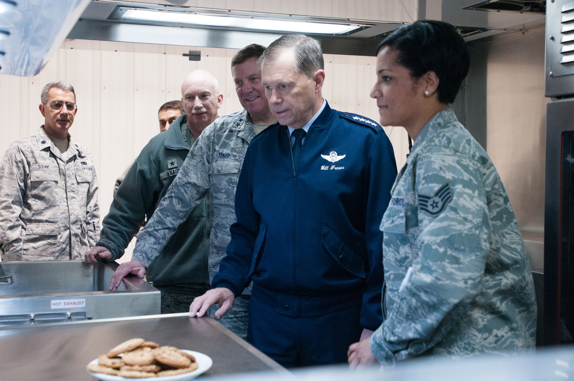 Staff Sgt. Aja Blair (right), a services training assistant for the Kentucky Air National Guard’s 123rd Force Support Squadron, shows off the unit's Disaster Relief Mobile Kitchen Trailer to General William M. Fraser III, commander of U.S. Transportation Command, during a tour of the 123rd Airlift Wing in Louisville, Ky., on March 12, 2013. (U.S. Air Force Photo by Master Sgt. Phil Speck)
