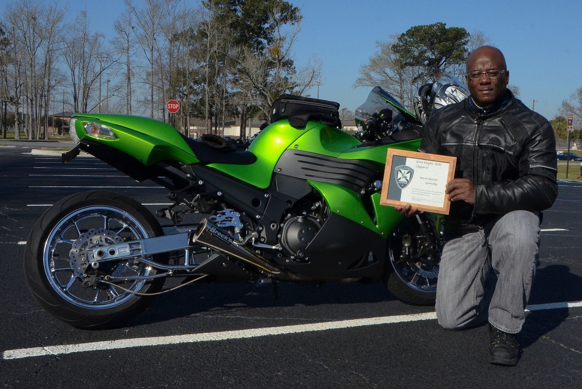 Technical Sgt. Robert Porter, 315th Aircraft Maintenance Squadron crew chief, displays his award for the best-in-show sport bike March 15, 2013, at the Joint Base Charleston – Air Base. More than 200 Airmen, Sailors, Soldiers, civilians and dependents from JB Charleston participated in the 2013 Joint Base Charleston Motorcycle Safety Rodeo throughout the Lowcountry. (U.S. Air Force photo/Airman 1st Class Jared Trimarchi)