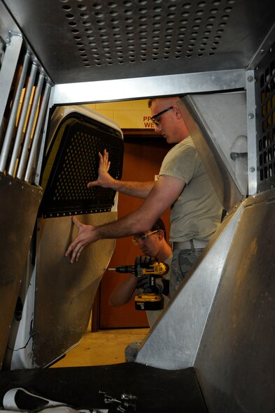 Airman 1st Class Cody Akers and Staff Sgt. Davis McClain, both from the 2nd Logistics Readiness Squadron Allied Trades section, drill paneling onto the door of a government owned vehicle on Barksdale Air Force Base, La., March 19. The allied trade shop's main responsibilities include tire repair and replacement and body work for Barksdale's fleet of vehicles ranging from fire trucks, maintenance and government owned vehicles. (U.S. Air Force photo/Airman 1st Class Andrew Moua)