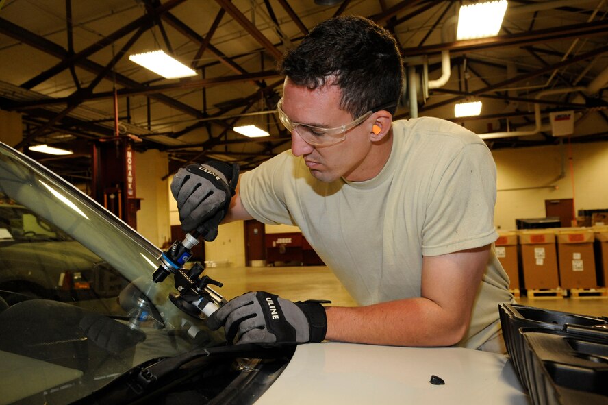 Staff Sgt. Davis McClain, 2nd Logistics Readiness Squadron Allied Trades section, repairs a car windshield on Barksdale Air Force Base, La., March 19. The allied trade shop's main responsibilities include tire repair and replacement and body work for Barksdale's fleet of vehicles ranging from fire trucks, maintenance and government owned vehicles. (U.S. Air Force photo/Airman 1st Class Andrew Moua)