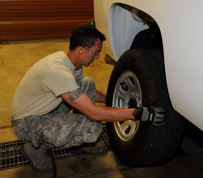 Staff Sgt. Davis McClain, 2nd Logistics Readiness Squadron Allied Trades section, removes a hub cap from a truck on Barksdale Air Force Base, La., March 19. The maintainers at the 2 LRS tire shop repair tires that contain nails, screws and bolts, broken valve stems, tires that have blown out from abnormal use, and normal wear and tear. They perform more than 100 tire changes each month. (U.S. Air Force photo/Airman 1st Class Andrew Moua)
