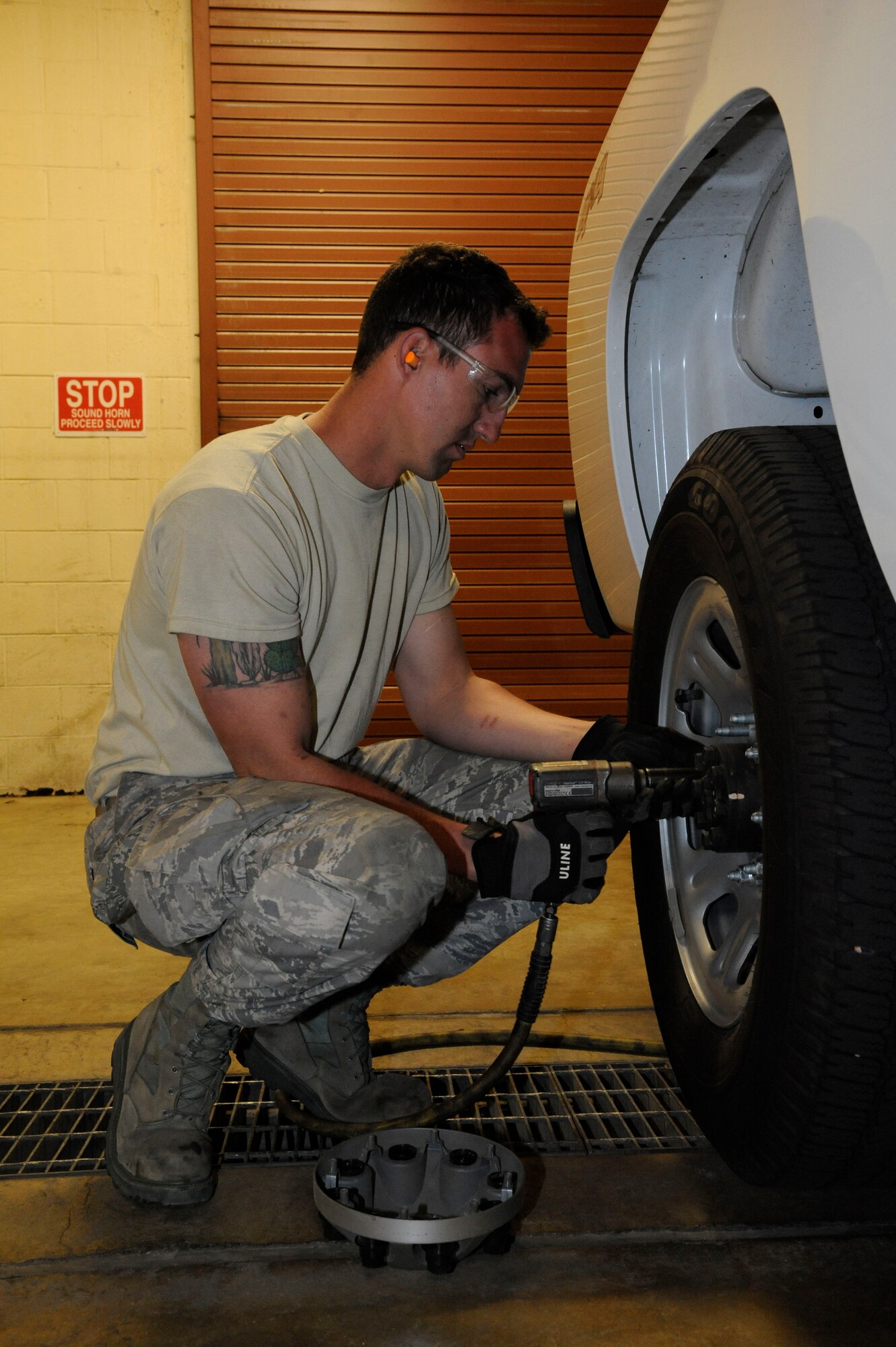 Staff Sgt. Davis McClain, 2nd Logistics Readiness Squadron Allied Trades section, removes a hub cap from a truck on Barksdale Air Force Base, La., March 19. The maintainers at the 2 LRS tire shop repair tires that contain nails, screws and bolts, broken valve stems, tires that have blown out from abnormal use, and normal wear and tear. They perform more than 100 tire changes each month. (U.S. Air Force photo/Airman 1st Class Andrew Moua)