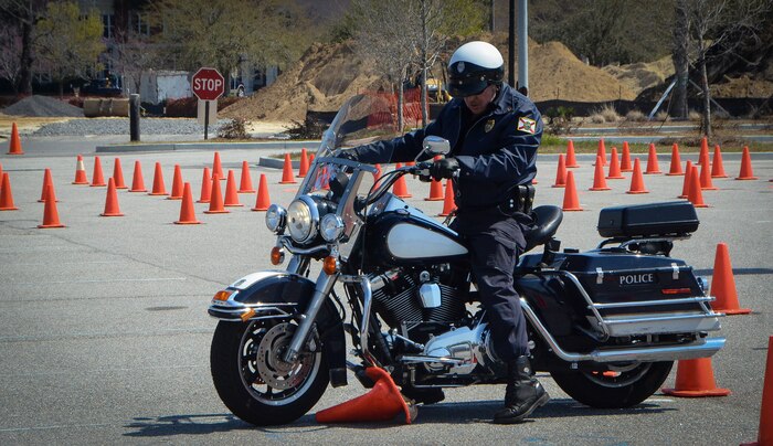 A deputy sheriff runs over a traffic cone during the Eighth Annual Palmetto  Police Motorcycle Rodeo March 15, 2013, at the North Charleston Coliseum. The event was part of the 2013 Joint Base Charleston Motorcycle Safety Rodeo. More than 200 Airmen, Sailors, Solders, civilians and dependents participated alongside more than 25 deputy sheriffs from South Carolina, Georgia and Florida. The Rodeo consisted of obstacle courses designed to tests the limits of a motorcycle and the handling skills of the operators. (U.S. Air Force photo/Airman 1st Class Jared Trimarchi)