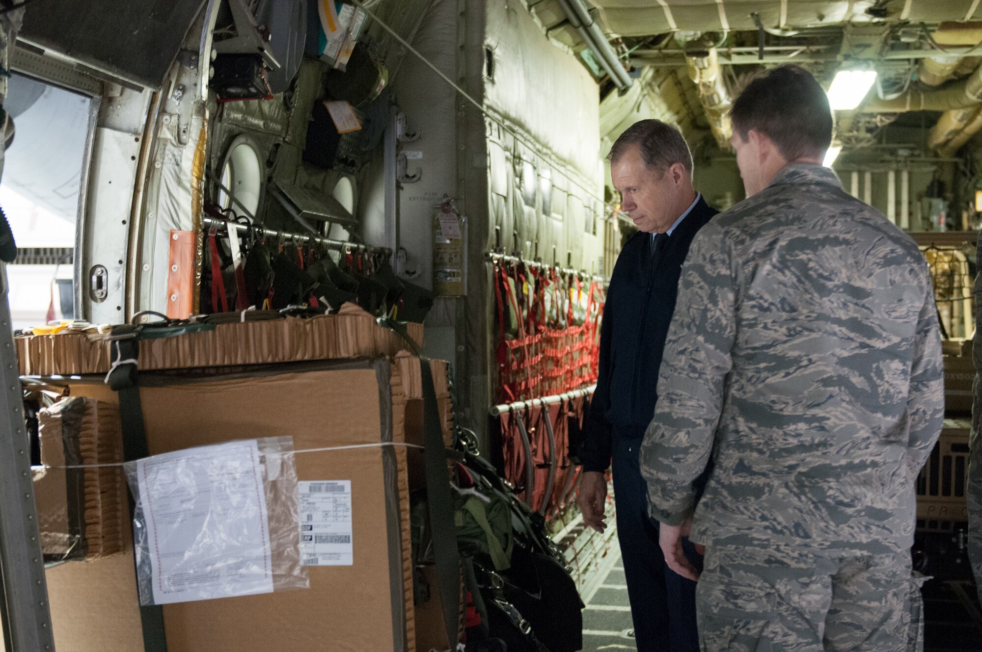 Lt. Col. Jeff Wilkinson (right), commander of the 123rd Special Tactics Squadron, demonstrates to Gen. William M. Fraser III, commander of U.S. Transportation Command, how his combat controllers are able to parachute from a C-130 with a small motorbike in order to conduct rapid surveys at non-functional airfields. Fraser was visiting the Kentucky Air National Guard Base in Louisville, Ky., on March 12, 2013, to learn more about the 123rd Airlift Wing. (U.S. Air Force Photo by Master Sgt. Phil Speck)