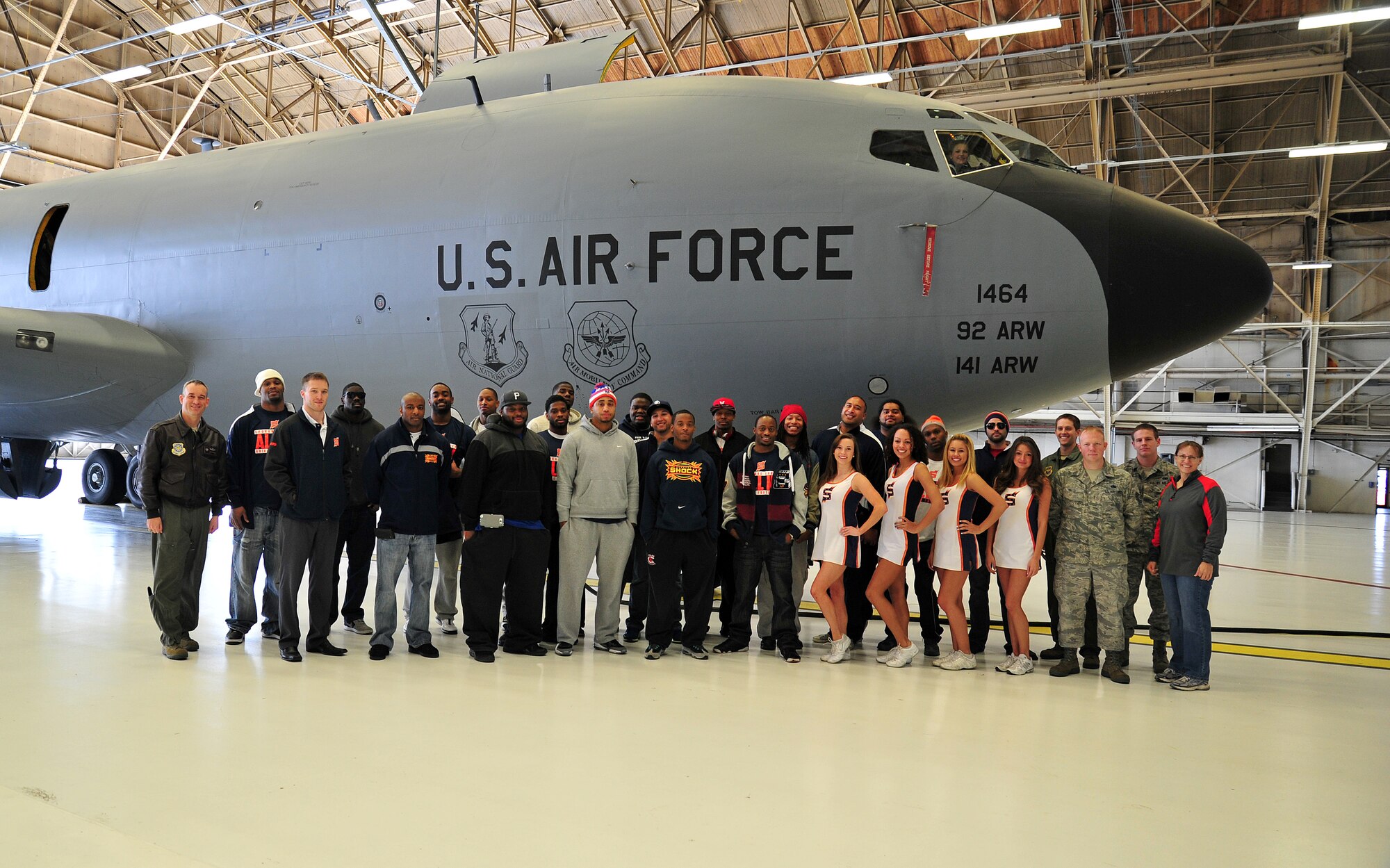Members of the arena football team, Spokane Shock, pose for a group photo in front of a KC-135 Stratotanker in a hangar at Fairchild Air Force Base, Wash., March 17, 2013. “I am very excited to be working with Fairchild Air Force Base this season as it's an honor to be involved with such great people,” said Andy Olson, Spokane Shock Arena Football head coach. (U.S. Air Force photo by Senior Airman Taylor Curry)