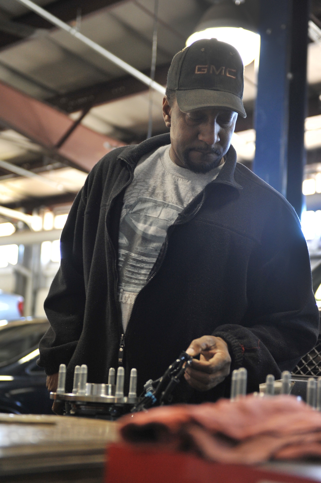 James Bell, an aviation electronics technician, prepares to replace the hubs on a truck at Spirit Auto, Whiteman Air Force Base, Mo., March 13, 2013. Spirit Auto offers an array of automotive services for Team Whiteman members. (U.S. Air Force photo by Heidi Hunt/Released) 