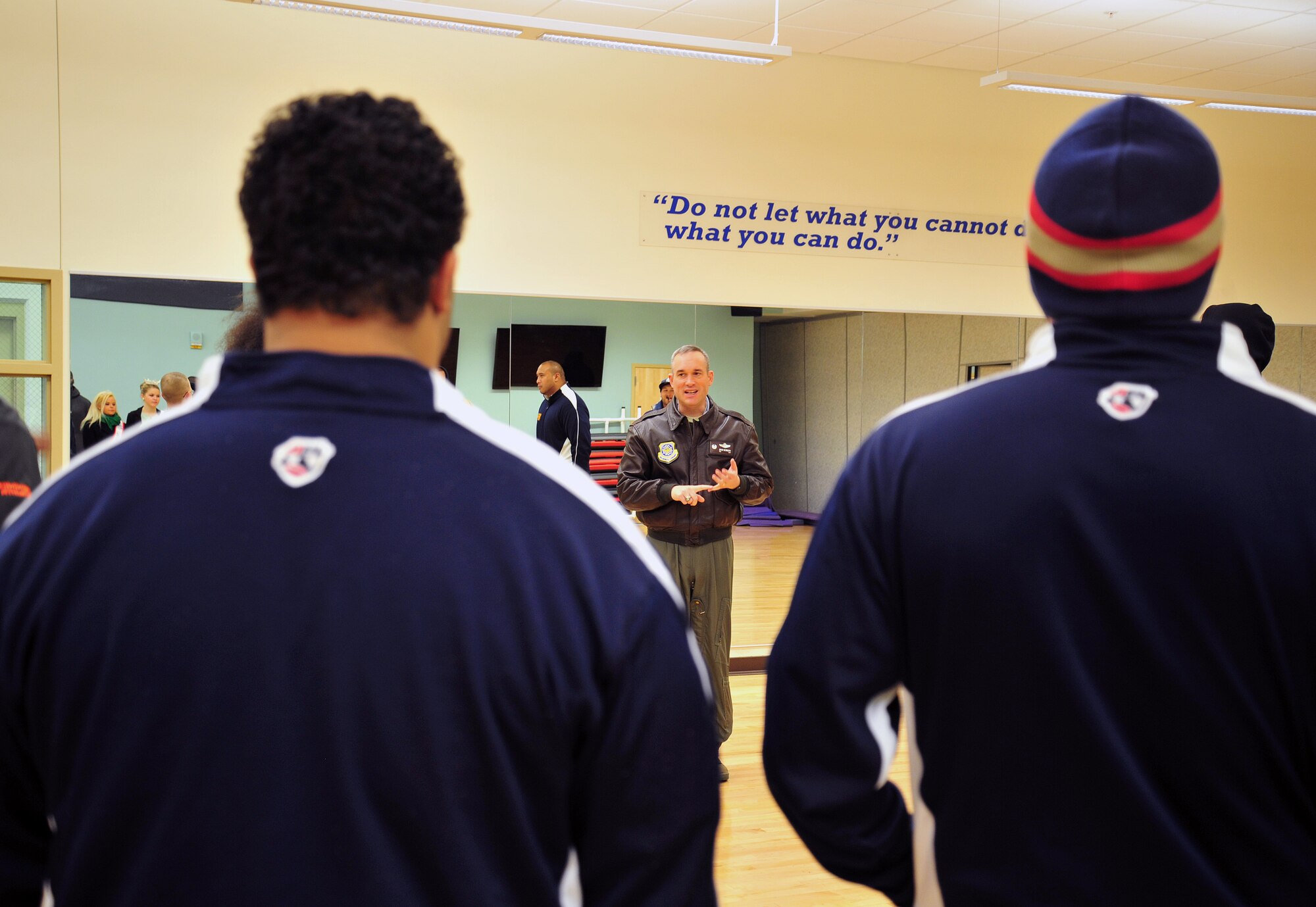Col. Brian Newberry, 92nd Air Refueling Wing commander, gives a tour of the fitness center to the Spokane Shock arena football team at Fairchild Air Force Base, Wash., March 17, 2013. The team came to Fairchild to announce their new starting line-up. (U.S. Air Force photo by Senior Airman Taylor Curry)