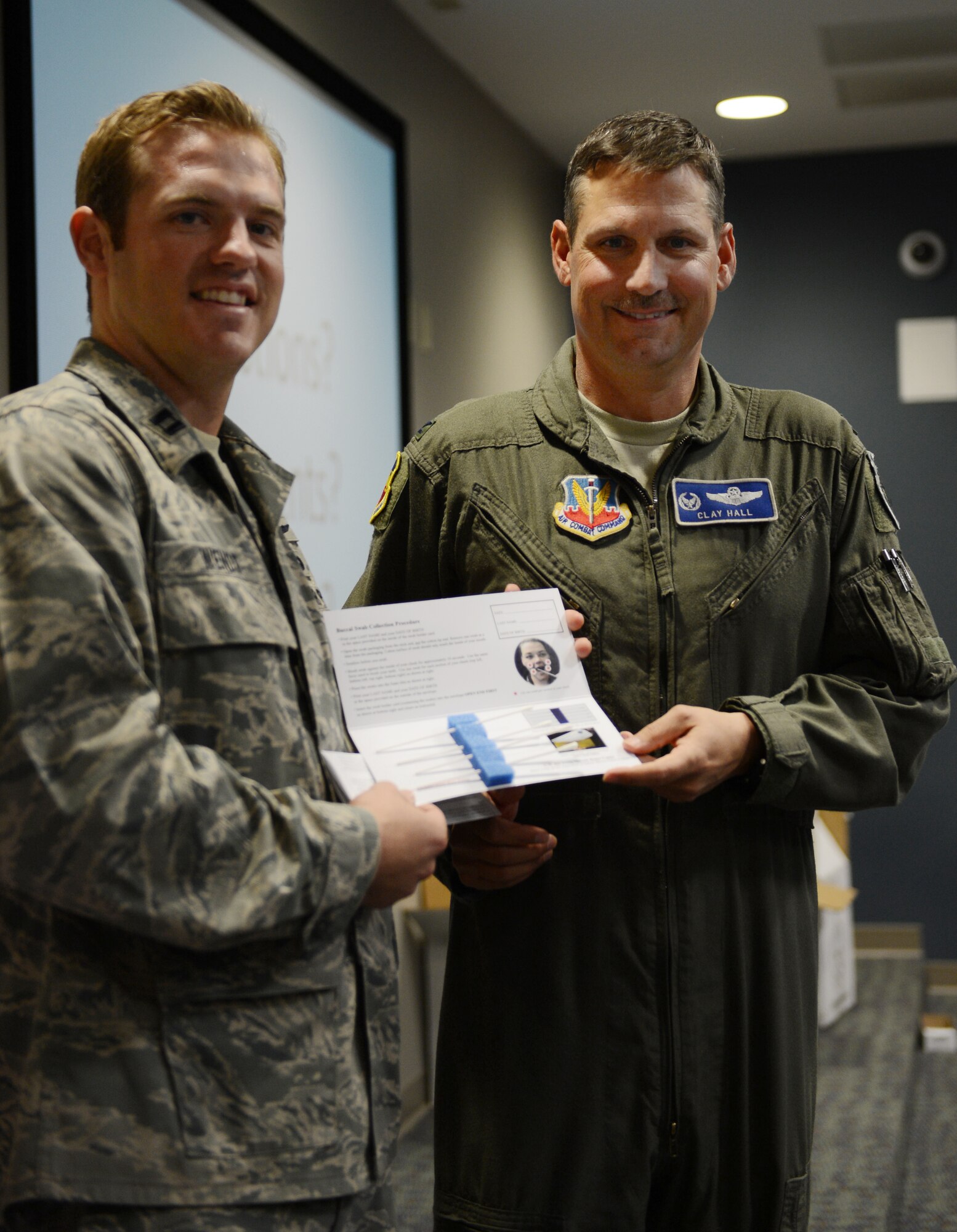 U.S. Air Force Capt. Neal Wendt, 609th Air Communications Squadron director of operations, gives Col. Clay Hall, 20th Fighter Wing commander, his swab kit as part of the registration for the Department of Defense marrow donor program at the deployment processing center, Shaw Air Force Base, S.C., March 18, 2013. The C.W. Bill Young Department of Defense marrow donor program officially kicked off at the DPC and will continue throughout the week at different locations. (U.S. Air Force photo by Senior Airman Tabatha Zarrella/Released)
