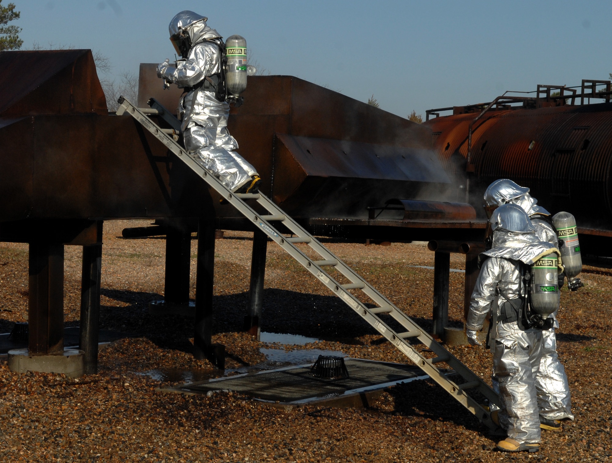 Firefighters from the 633rd Civil Engineer Squadron simulate clearing a cockpit during a live-fire exercise March 13, 2013, at Langley Air Force Base, Va. Each firefighter is required to undergo live-fire training semi-annually. (U.S. Air Force Photo by Airman 1st Class Austin Harvill/Released)