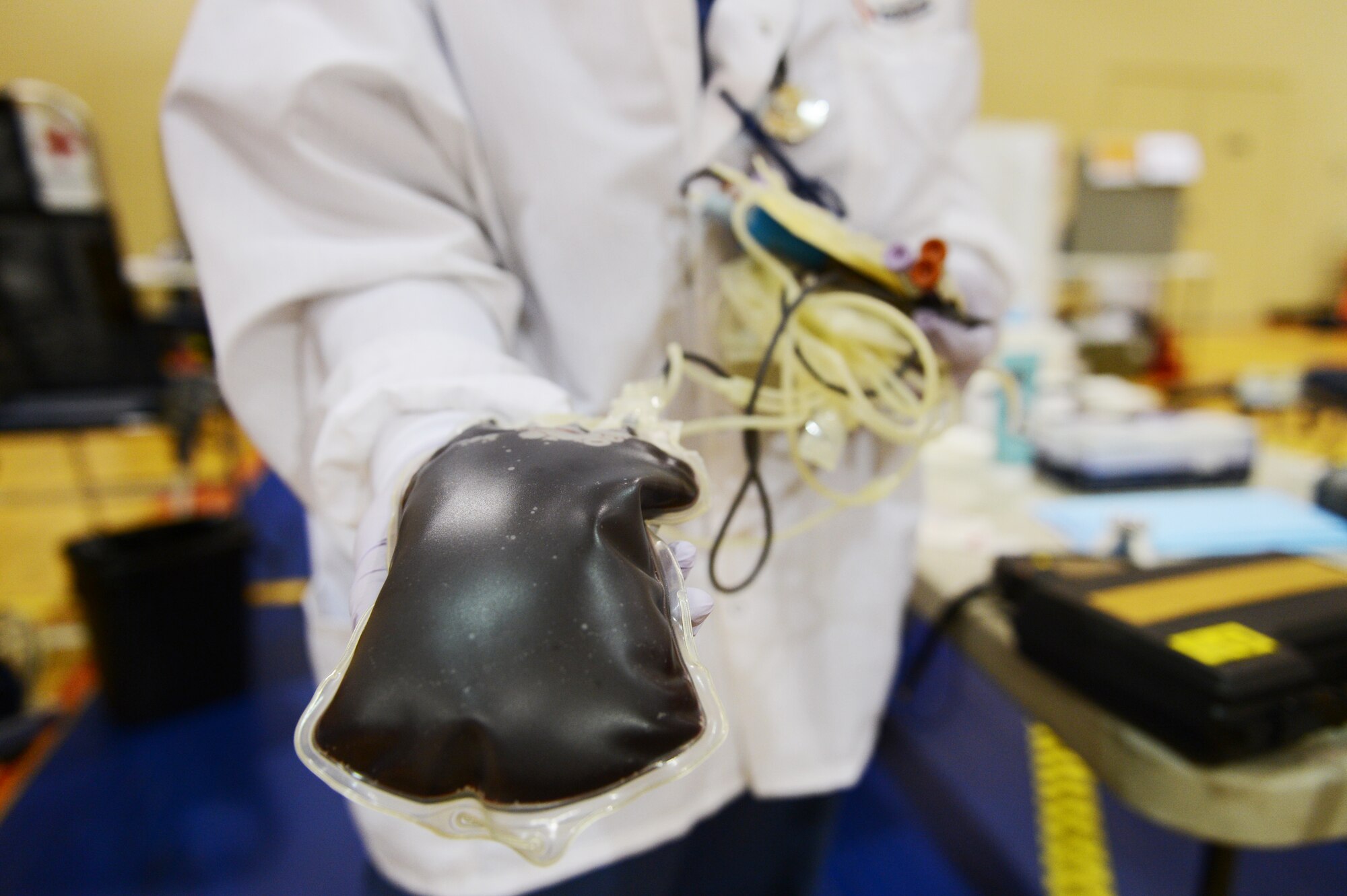 American Red Cross collections technician, holds about a pint of blood after retrieving it from a donor here at the fitness center, Shaw Air Force Base, S.C., March 14, 2013. Shaw's American Red Cross holds quarterly blood drives each year. (U.S. Air Force photo by Senior Airman Tabatha Zarrella/Released)

