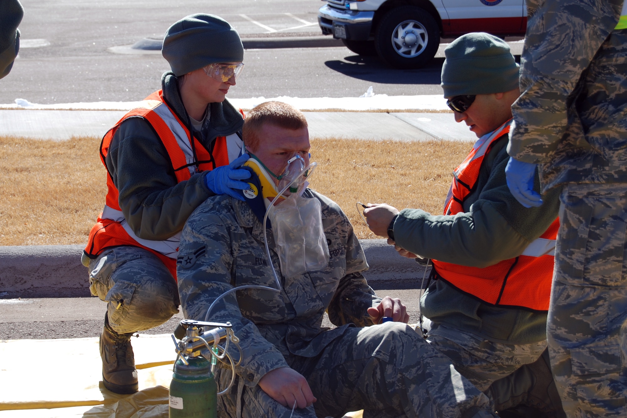 Medical responders from the 21st Medical Group treat a casualty from a three vehicle accident on Hamilton Avenue during the Condor Crest exercise Feb. 28. The accident scenario was caused by an ice storm and resulted in a fuel spill, 20 casualties and two deaths. The Condor Crest emergency response exercise was held Feb. 25-March 1 as part of the 21st Space Wing's continued commitment to ensure base readiness. (U.S. Air Force photo/Lea Johnson)