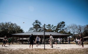Airmen with the 437th Aerial Port Squadron play a game of volleyball during Wingman Day March 14, 2013, at the Joint Base Charleston – Air Base picnic grounds. During Wingman Day, Joint Base Charleston Airmen participated in activities such as resiliency training, group discussions and scavenger hunts as well as sports and barbecues with their units.  (U.S. Air Force photo/ Senior Airman Dennis Sloan)