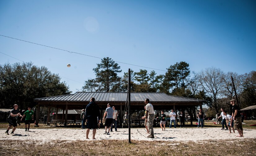Airmen with the 437th Aerial Port Squadron play a game of volleyball during Wingman Day March 14, 2013, at the Joint Base Charleston – Air Base picnic grounds. During Wingman Day, Joint Base Charleston Airmen participated in activities such as resiliency training, group discussions and scavenger hunts as well as sports and barbecues with their units.  (U.S. Air Force photo/ Senior Airman Dennis Sloan)