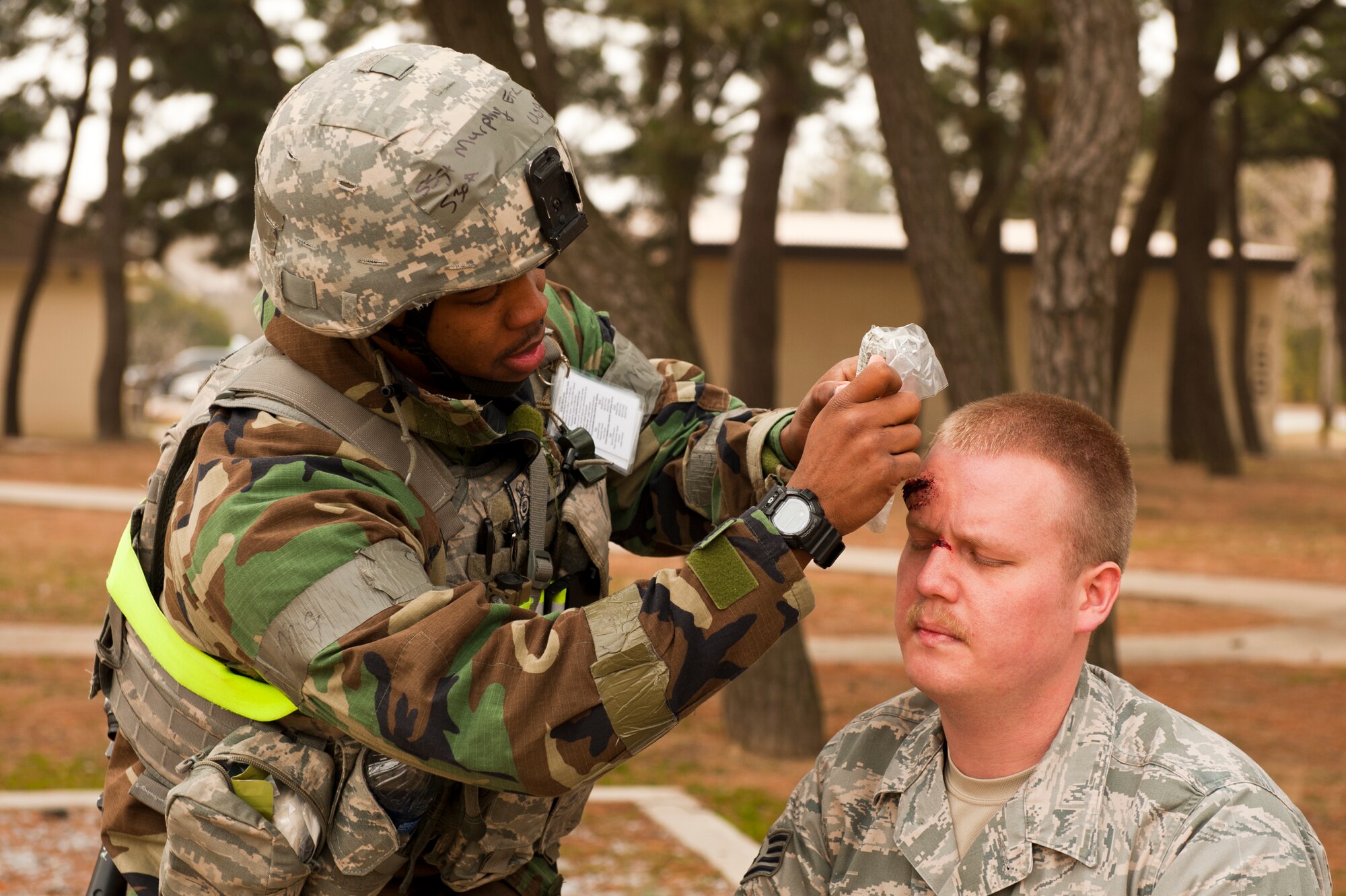 Staff Sgt. Eric Murphy, 8th Security Forces Squadron, treats the head wound of Staff Sgt. Michael O’Brien, 8th Fighter Wing role-player, during exercise Beverly Midnight 13-2 at Kunsan Air Base, Republic of Korea, March 19, 2013. The simulated injury adds a sense of realism to the training scenario. (U.S. Air Force photo by Staff Sgt. Jonathan Fowler/Released)