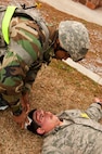 Staff Sgt. Eric Murphy, 8th Security Forces Squadron, treats the head wound of Senior Airman Ian Painter, 8th Fighter Wing role-player, during exercise Beverly Midnight 13-2 at Kunsan Air Base, Republic of Korea, March 19, 2013. The simulated injury adds a sense of realism to the training scenario. (U.S. Air Force photo by Staff Sgt. Jonathan Fowler/Released)