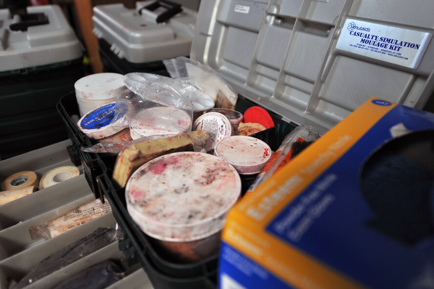 Make-up used to apply moulage to mock patients is set aside as Airmen from the 51st Medical Group apply fake wounds on Airmen during Operational Readiness Exercise Beverly Midnight 13-02 at Osan Air Base, Republic of Korea, March 19, 2013. Moulage victims are used to help Airmen and medical professionals better learn how to give proper medical treatment after simulated attacks on the base. (U.S. Air Force photo/Senior Airman Alexis Siekert)