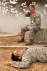 Staff Sgt. Michael O’Brien (top) and Senior Airman Ian Painter,  8th Fighter Wing role-players, simulate injuries during exercise Beverly Midnight 13-2 at Kunsan Air Base, Republic of Korea, March 19, 2013. 8th FW role-players are an integral part of Kunsan exercises and help make the scenarios realistic. (U.S. Air Force photo by Staff Sgt. Jonathan Fowler/Released)