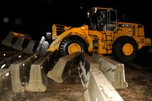 An Airman from the 8th Civil Engineer Squadron uses a forklift to pick-up barricades during exercise Beverly Midnight 13-2 at Kunsan Air Base, Republic of Korea, March 17, 2013. The barricades helped provide a protective buffer for buildings on base during the exercise. (U.S. Air Force photo/Senior Airman Marcus Morris)