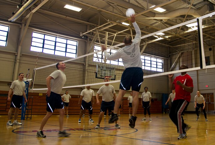 Members from the 628th Air Base Wing staff agencies compete in a game of volleyball between company grade and noncommissioned officers during Wingman Day March 14, 2013, at the Fitness Center on Joint Base Charleston – Air Base, S.C. Wingman Day, a quarterly event, allows Airmen to take a break from their daily duties and come together to focus on various key topics that impact their personal and professional lives. (U.S. Air Force photo/Staff Sgt. Rasheen Douglas)