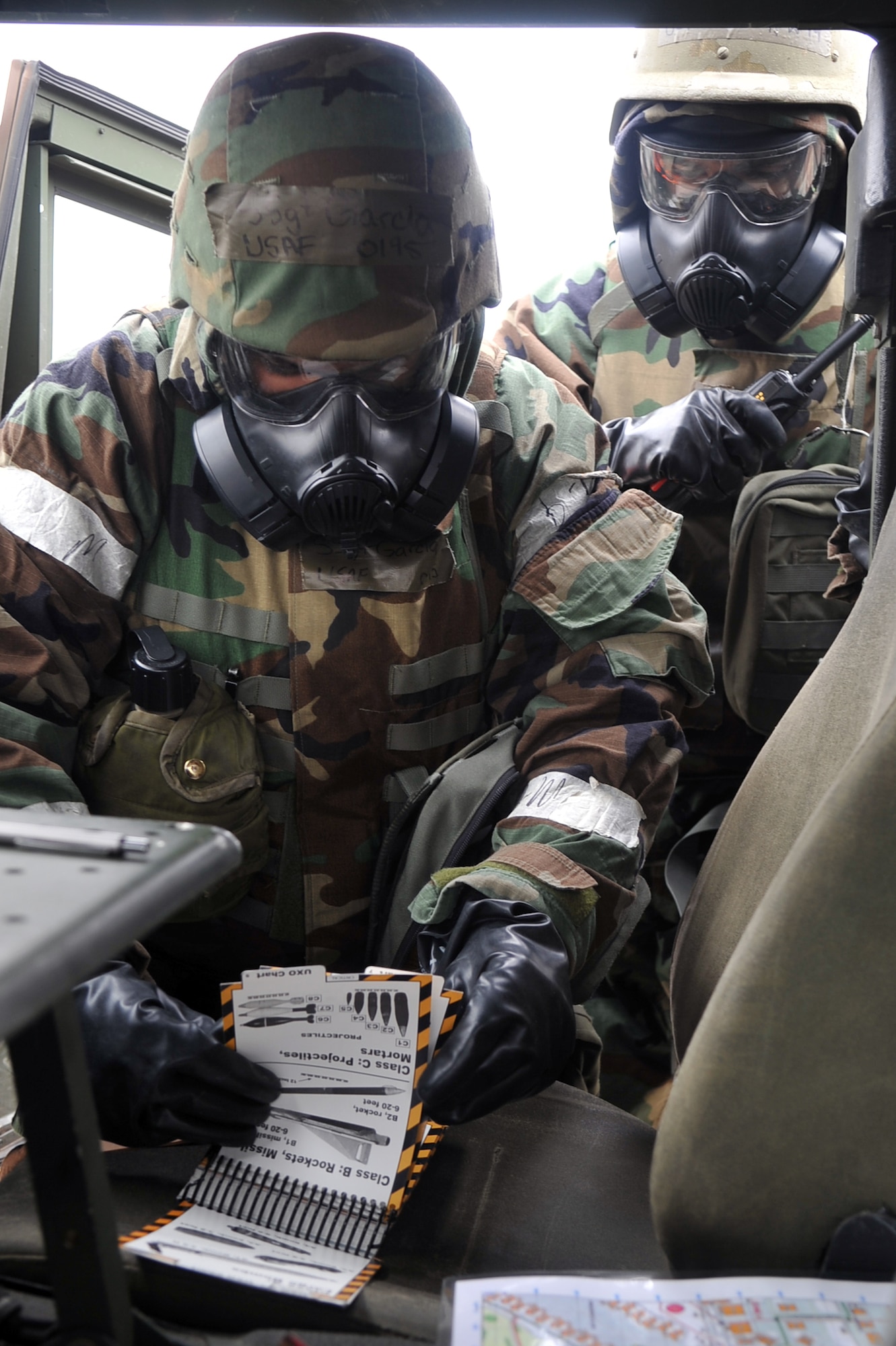 Staff Sgt. Daniel Garcia (left) and Airman 1st Class Colin Josephson, Airmen with the 51st Civil Engineer Squadron Heating Ventilation and Air Conditioning shop, reference an Airman’s Manual after spotting an unexploded ordnance during Operational Readiness Exercise Beverly Midnight 13-02 at Osan Air Base, Republic of Korea, March 19, 2013.  The UXO was spotted while the Airmen were performing a post attack reconnaissance sweep.  Throughout the week-long exercise, Airmen throughout the base will be faced with several different types of scenarios that will help prepare for possible real-world contingencies. (U.S. Air Force photo/Senior Airman Alexis Siekert) 
