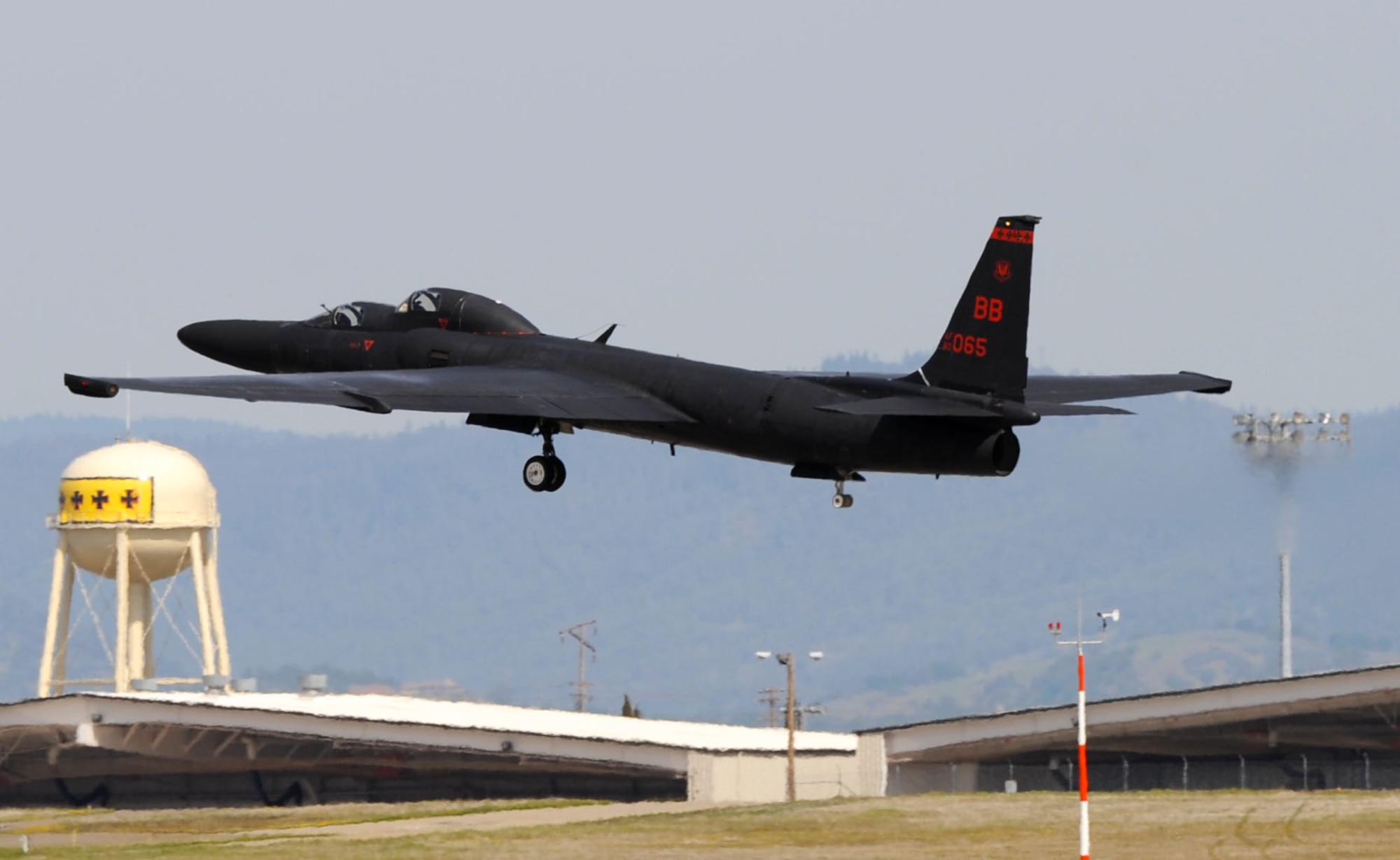 A U-2 “Dragon Lady” takes off from Beale Air Force Base, Calif., March 15, 2013. U-2 pilots train at Beale using two-seat aircraft before deploying for operational missions. The four black crosses on the tower in the background represent four WWI offensives in which squadrons later assigned to the 9th Wing participated. (U.S. Air Force photo by Airman 1st Class Bobby Cummings/Released