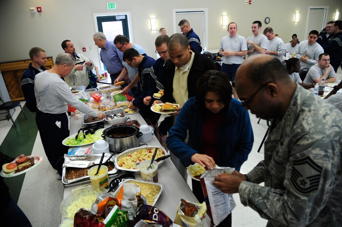 Members from the 628th Air Base Wing staff agencies take a lunch break during Wingman Day March 14, 2013, at the Chapel Annex on Joint Base Charleston – Air Base. During Wingman Day, Joint Base Charleston Airmen participated in activities such as resiliency training, group discussions and scavenger hunts as well as sports and barbecues with their units. (U.S. Air Force photo/Staff Sgt. Rasheen Douglas)