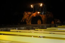 An Airman from the 8th Civil Engineer Squadron uses a forklift to pick-up barricades during exercise Beverly Midnight 13-2 at Kunsan Air Base, Republic of Korea, March 17, 2013. The barricades limited traffic on base during the exercise. (U.S. Air Force photo/Senior Airman Marcus Morris)