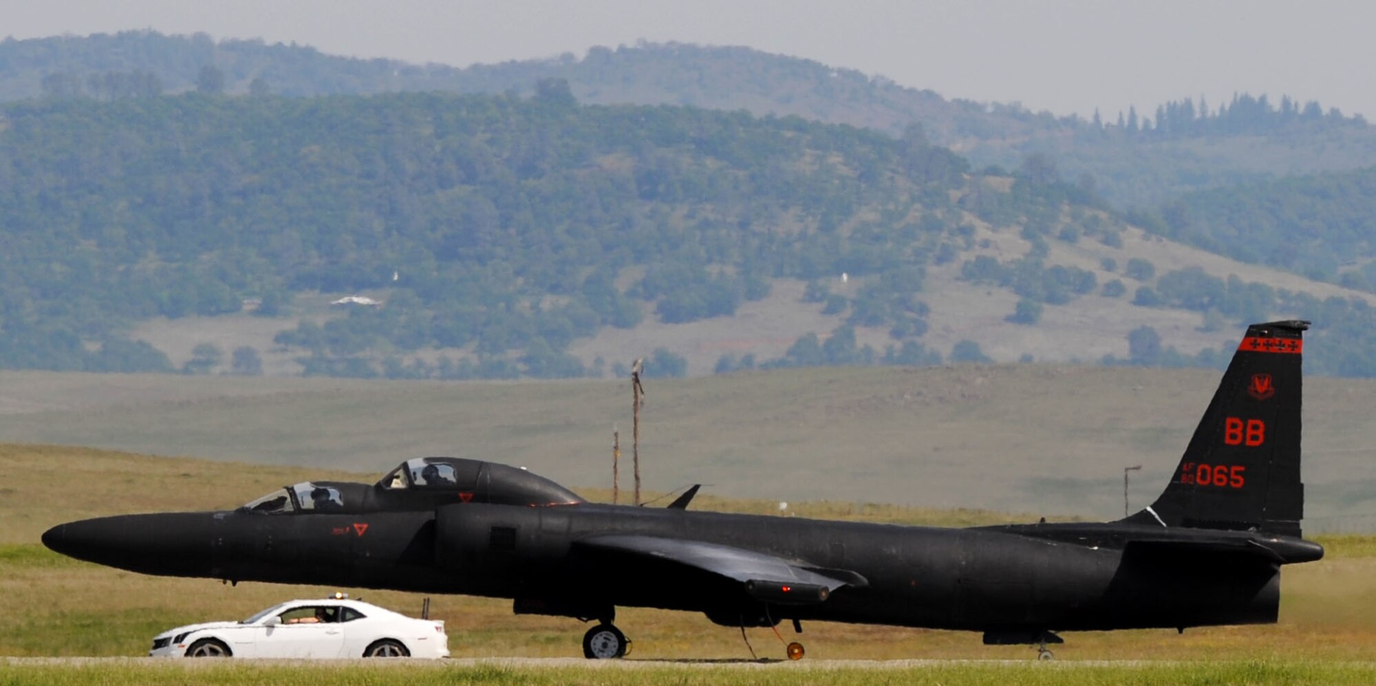 A U-2 “Dragon Lady” prepares to take off as a chase car trails the aircraft on Beale Air Force Base, Calif., March 15, 2013. Chase cars travel at high speeds along the runway to guide the aircraft during takeoffs and landings.(U.S. Air Force photo by Airman 1st Class Bobby Cummings/Released)