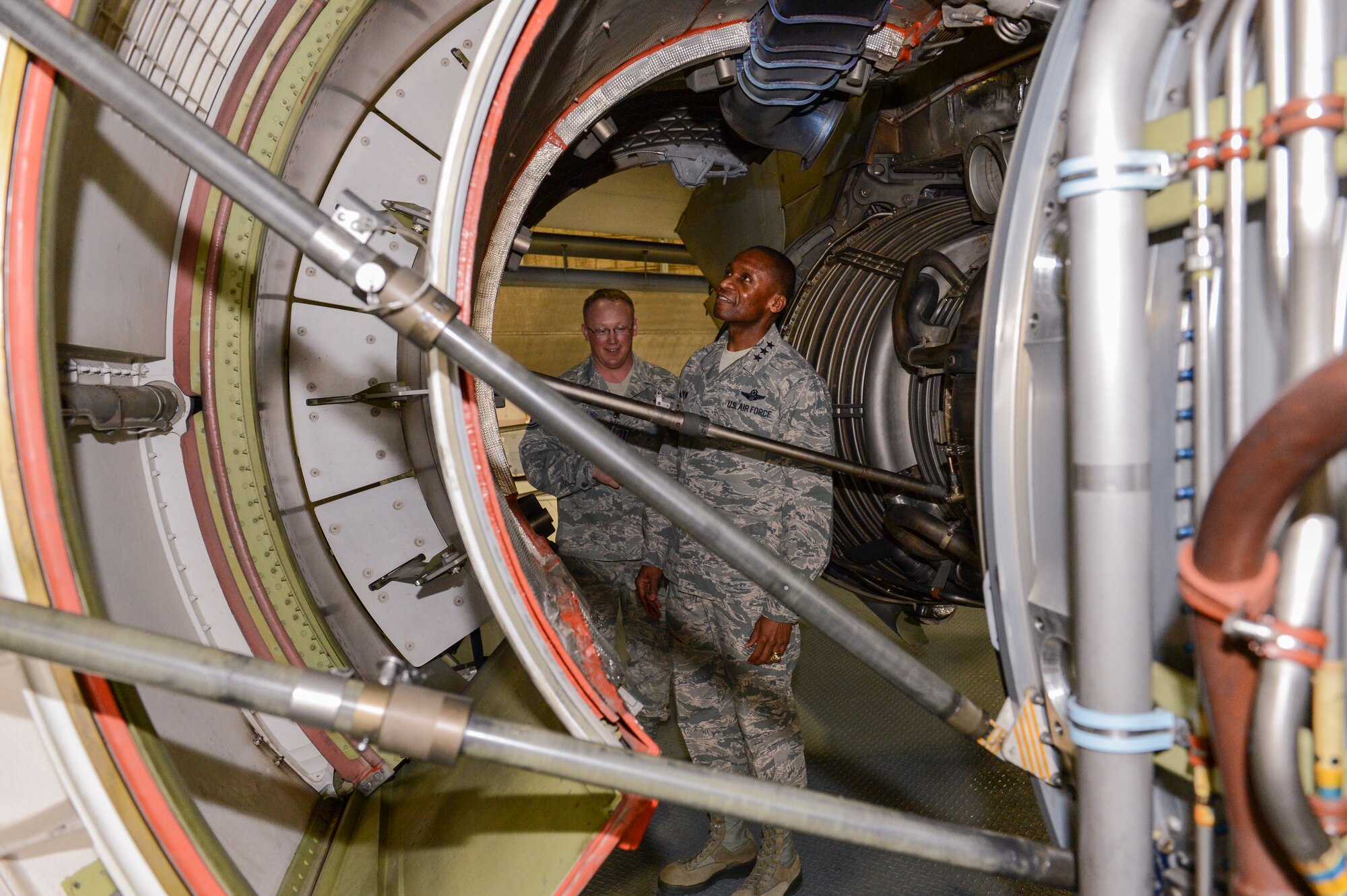 Tech. Sgt. Brook Mertens, 62nd Maintenance Squadron Maintenance Flight shift supervisor (left), and Lt. Gen. Darren McDew, 18th Air Force commander, use a maintenance platform to stand underneath the engine cowling of a C-17 Globemaster III aircraft in a hangar March 15, 2013 at Joint Base Lewis-McChord, Wash. Mertens demonstrated the safety and efficiency of the platform as compared to traditional maintenance stands. (U.S. Air Force photo/Tech. Sgt. Sean Tobin)
