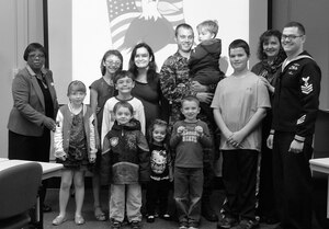 Melissa Wrighten (left), Navy Federal Credit Union employee, and Angela Gordon (second to right), Trust Federal Credit Union employee, present gift cards to the winners of the 2013 Joint Base Charleston Military Saves Campaign which took place from Feb. 20, 2013 to March 2, 2013. Military Saves Week is a dedicated opportunity for the military and civilian community to come together to emphasize the importance of saving while encouraging individuals to take action. (Courtesy photo)