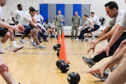 Airmen from the 437th Maintenance Operations Squadron, race toward dodge balls during Wingman Day March 14, 2013, at the Joint Base Charleston – Air Base Fitness Center. Wingman Day, a quarterly event, allows Airmen to take a break from their daily duties and come together to focus on various key topics that impact their personal and professional lives.  (Courtesy photo)