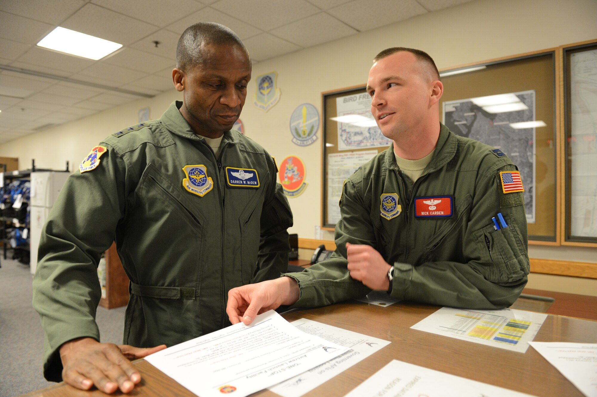 Capt. Nick Carden, 62nd Operations Group Readiness Flight Commander (right), briefs Lt. Gen. Darren McDew, 18th Air Force commander, on the Post Mission Review process March 14, 2013 at Joint Base Lewis-McChord, Wash. The 62nd OG's PMR process ensures accurate and timely crew data verification for flight crews. (U.S. Air Force photo/Tech. Sgt. Sean Tobin)