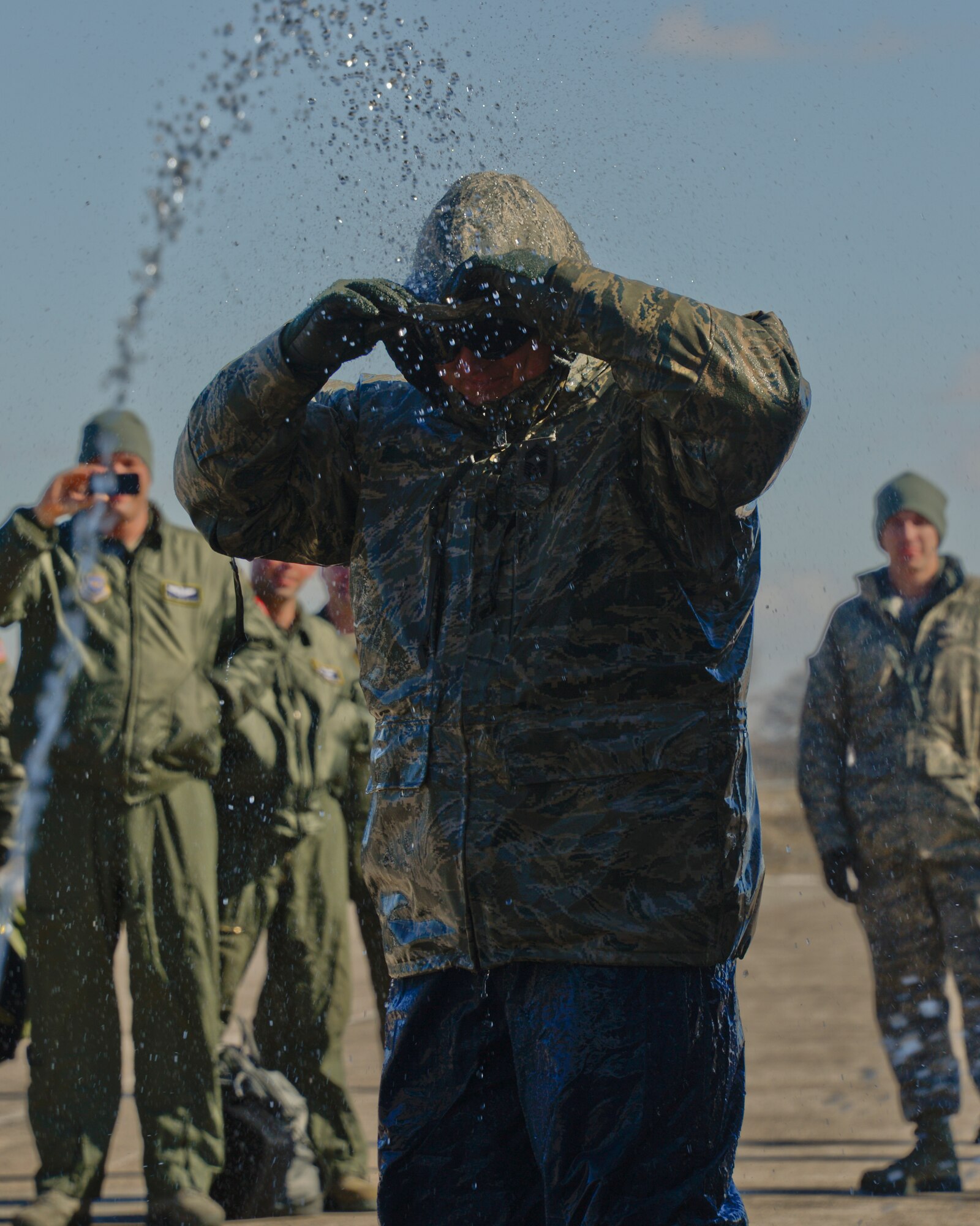 Airmen from the 133rd Airlift Wing spray a bridge of water over Chief Master Sgt. Jim Ricci, 109th Airlift Squadron in St. Paul, Minn., Mar. 16, 2013. Ricci is retiring from the military after over 35 years of service. 
(U.S. Air Force photo by Staff Sgt. Amy M. Lovgren/Released)